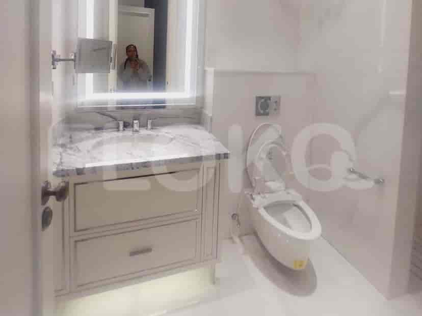 Bathroom with a vanity, mirror, and a toilet.