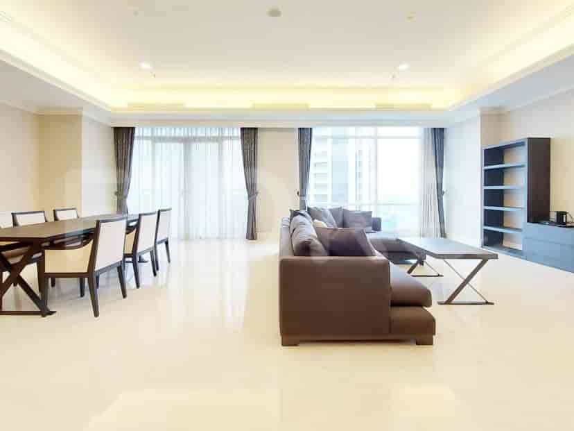Spacious open-plan living and dining area with white marble flooring, featuring a grey sofa, dining table, and large windows.