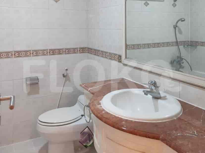A bathroom featuring a sink, toilet, and mirror.
