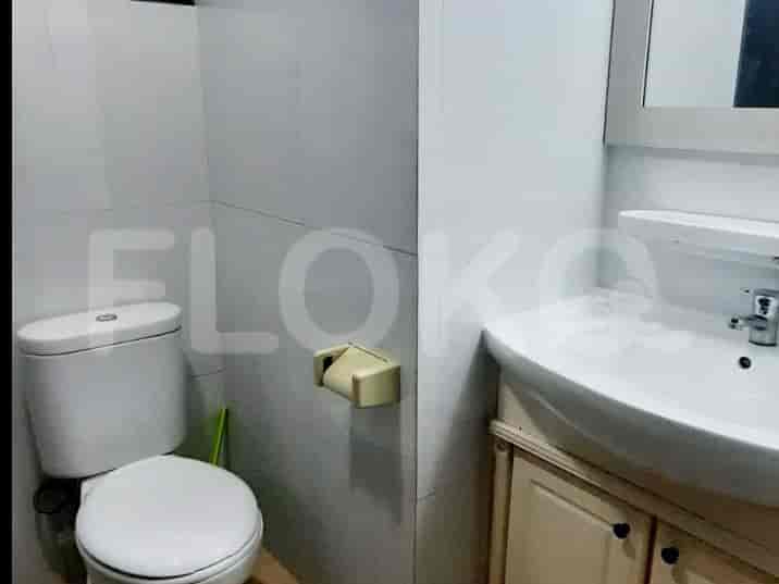 A bathroom with a toilet, sink, and vanity.