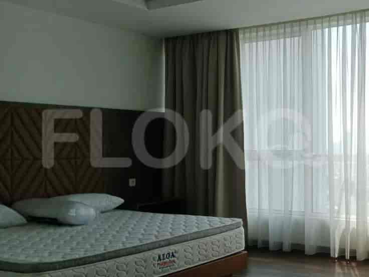 Bedroom with a bed, curtains, and a window.