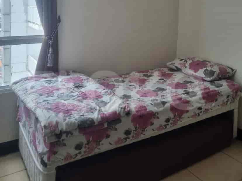 Cozy bedroom with a single bed and floral bedding.