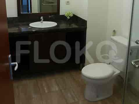 A bathroom with a sink, mirror, and toilet.