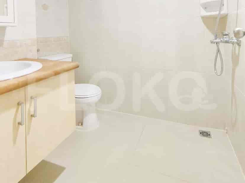 A bathroom with a toilet, sink, and shower area.