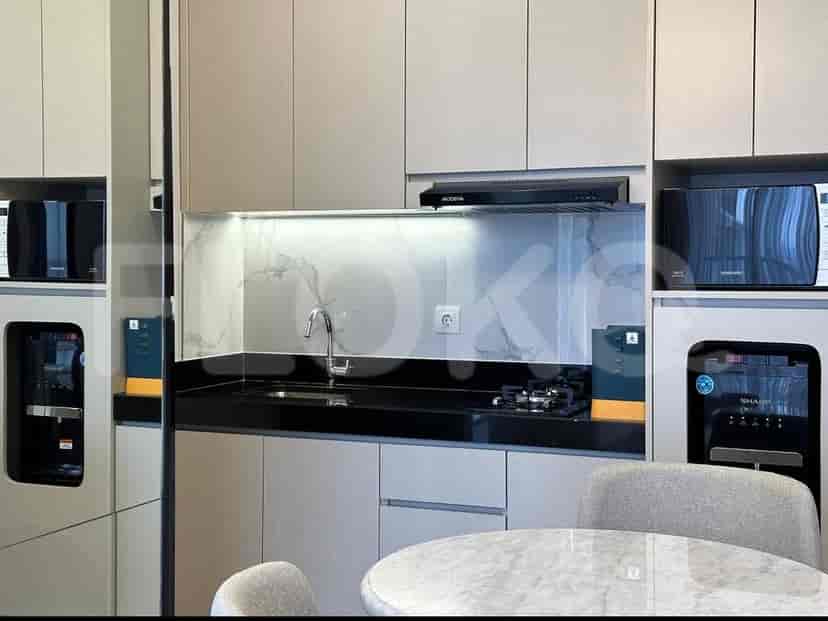 A compact kitchen area with cabinets, a stove, sink, and appliances.
