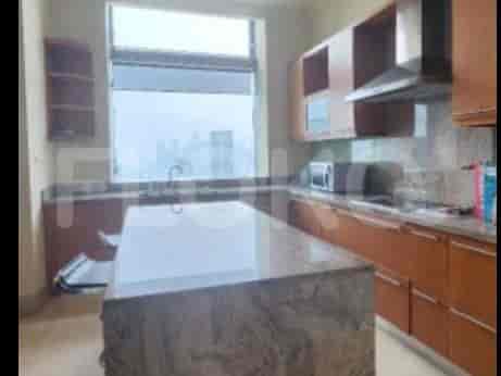 A modern kitchen with granite countertops, wooden cabinets, and a large island.