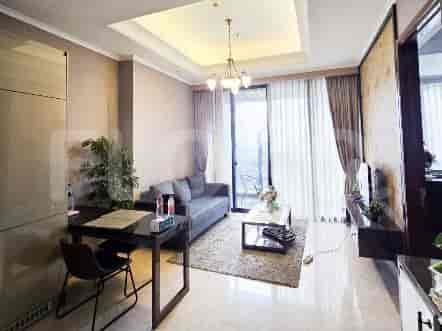 Spacious living room with a modern grey sofa, a coffee table, and city views.