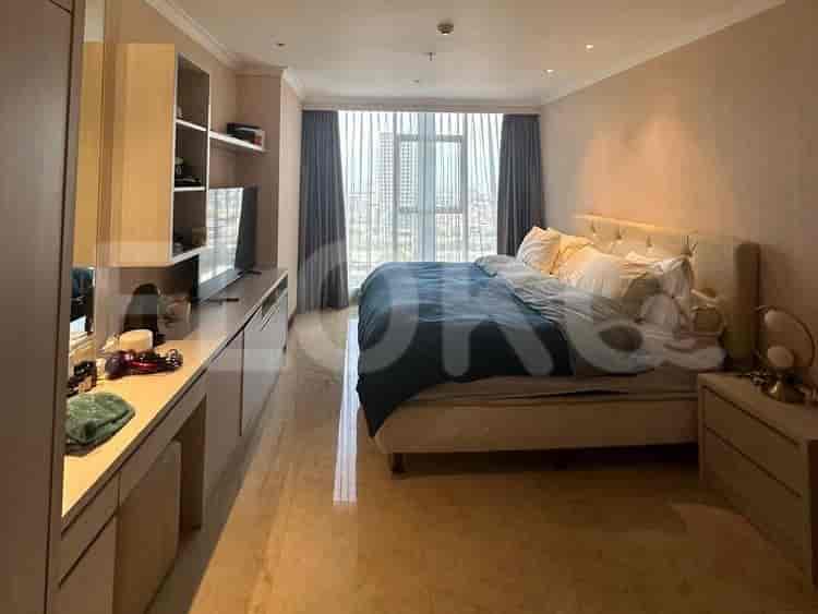 A master bedroom with a bed, desk, and a view.