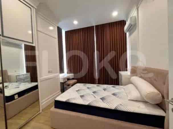 A bedroom with a queen-sized bed, a mirrored wardrobe, and a dressing table.