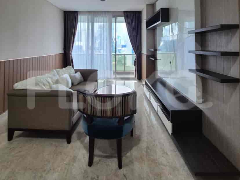 A modern living room with a grey sofa, coffee table, and a wall-mounted entertainment unit with shelves.