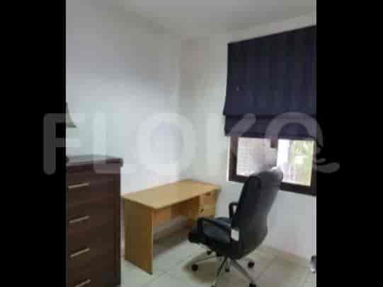 A home office with a desk, chair, and chest of drawers.