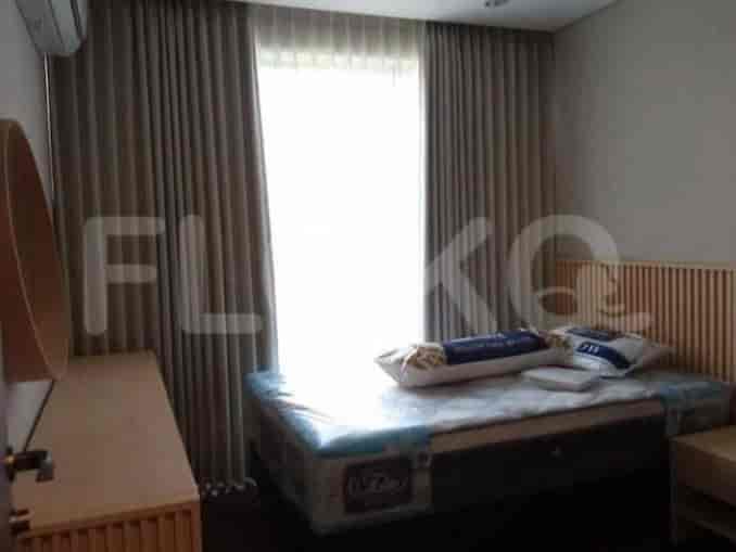 Bedroom with a bed and curtains.
