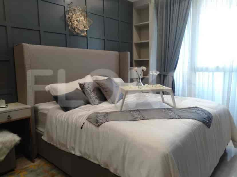 A modern bedroom with a large bed, patterned headboard, and stylish decor.