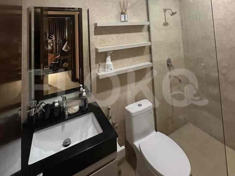 A contemporary bathroom with a sink, toilet, and shower.