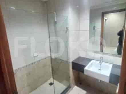 A modern bathroom with a walk-in shower and a floating sink.