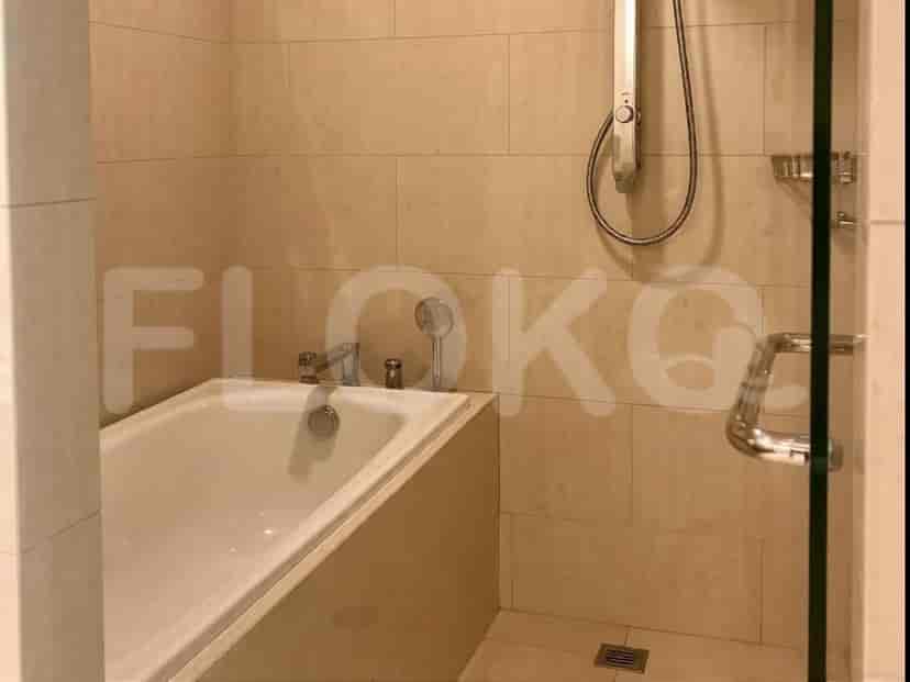 A bathroom with a bathtub, showerhead, faucet, and tiled walls.