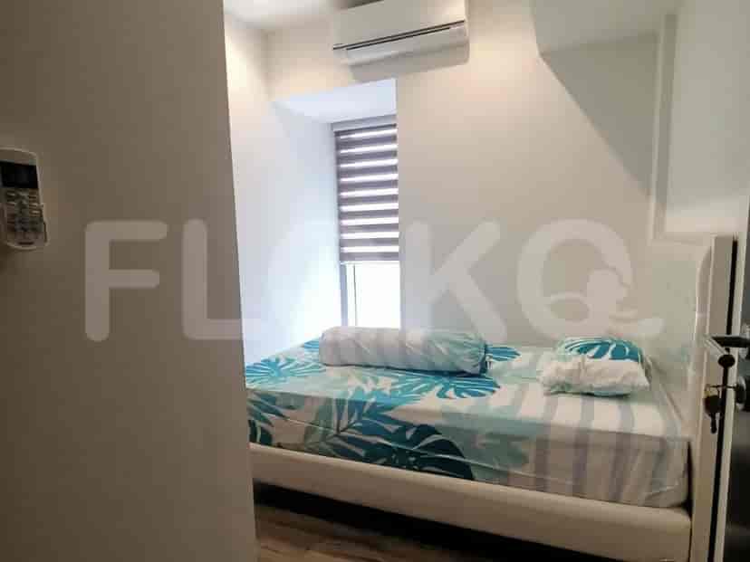 A cozy guest bedroom with a single bed and blinds.