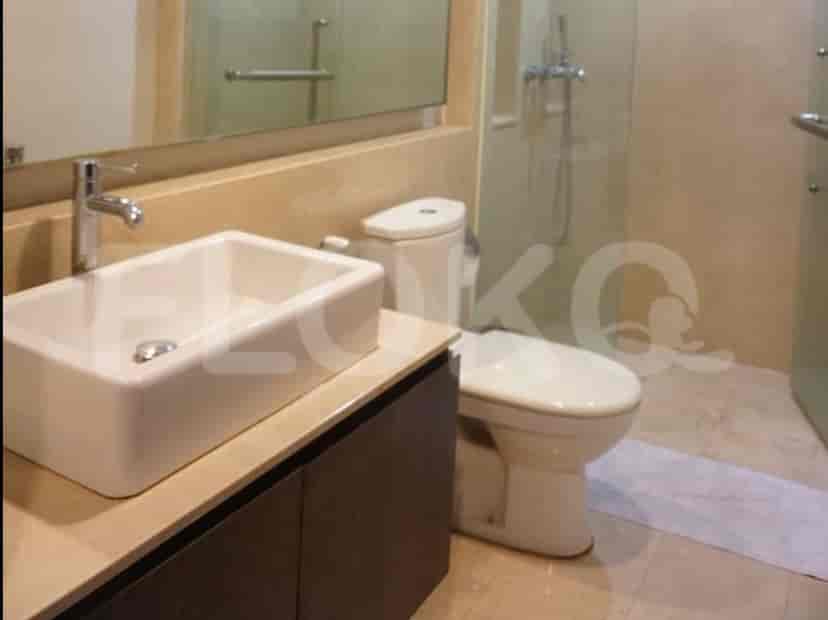 A modern bathroom with a rectangular sink, toilet, and a glass-enclosed shower.