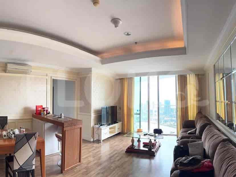 Spacious living area with wooden bar, large windows, and a comfortable seating area.