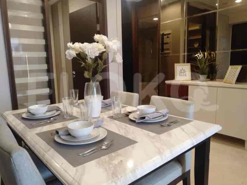 A dining area with a marble table, seating for six, and decorative flowers.