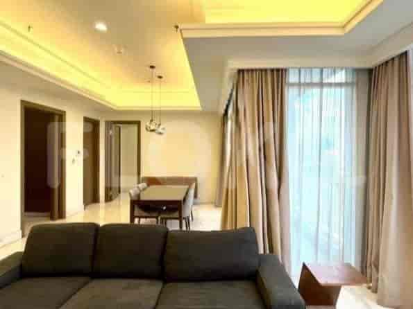 Spacious living area with a large window, sofa, and dining table.