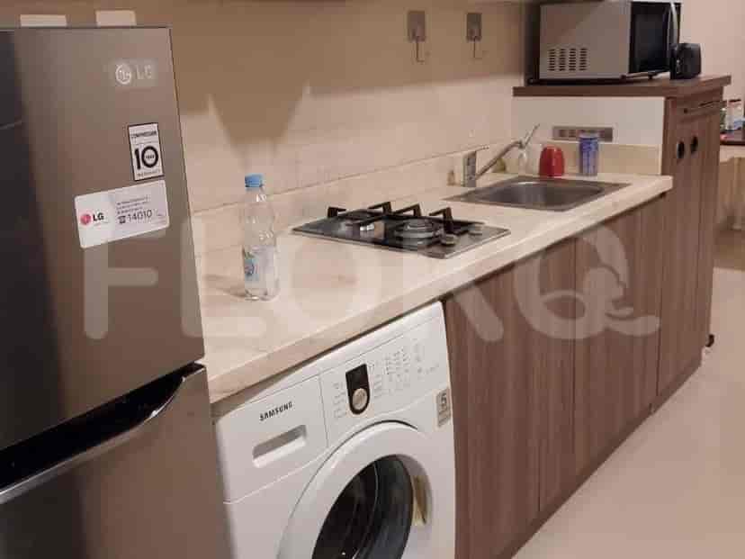 A close-up of the kitchen counter showing a stove, sink, and appliances.