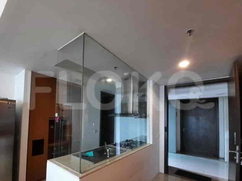 A modern kitchen with glass partition.