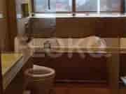Bedroom with a double bed and sitting area with a small sofa.