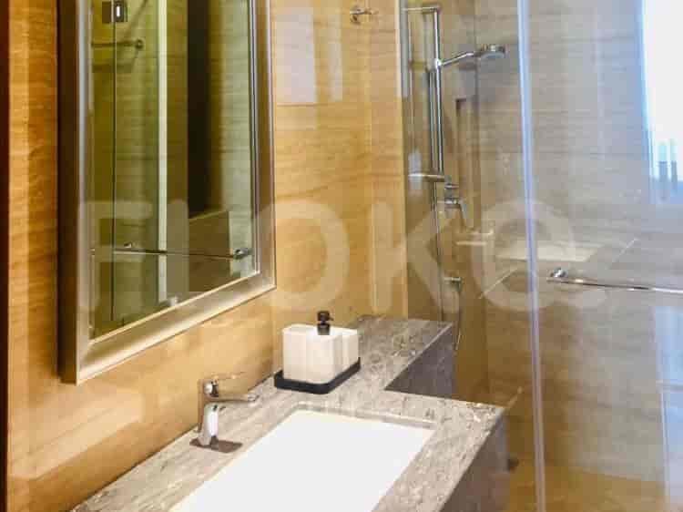 A bathroom with a sink, a mirror, a rain shower, and a bathtub.