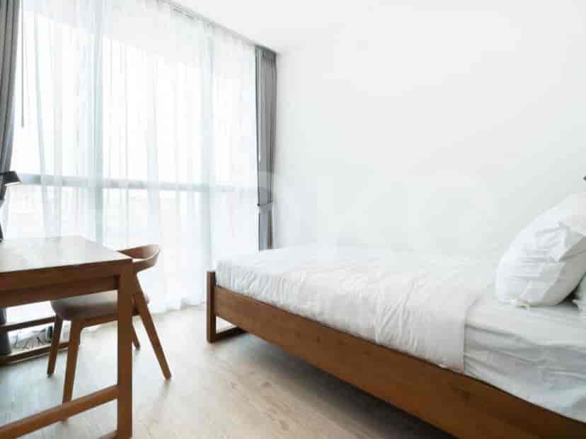 Bedroom with a single bed and a study desk.