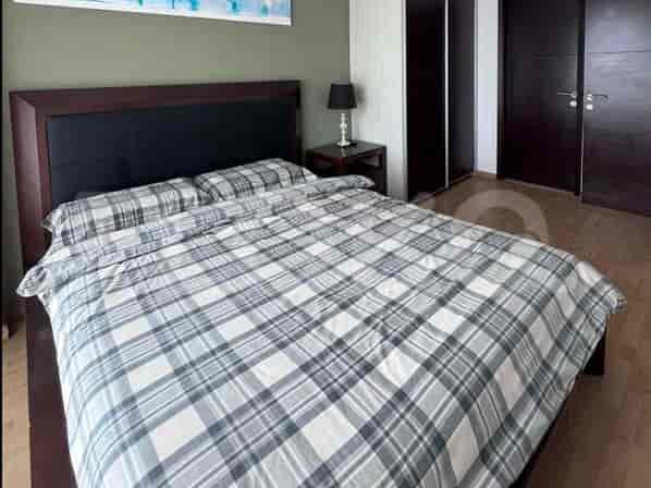 Comfortable bedroom with a queen-sized bed featuring a plaid patterned duvet cover.