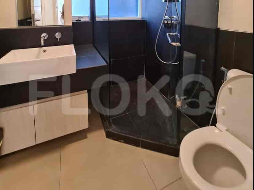 A modern bathroom with a shower, a sink, and a toilet.