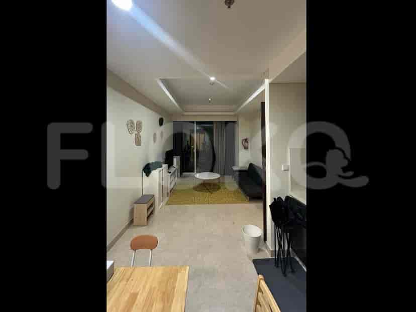 A modern living room with a large window, a sofa, a coffee table, and a TV console.