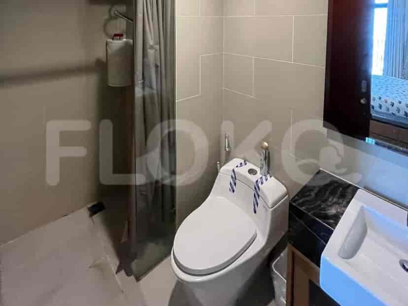 A bathroom with a toilet, sink, and shower.