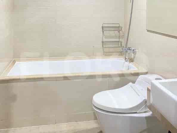 A bathroom with a bathtub, toilet, and sink.