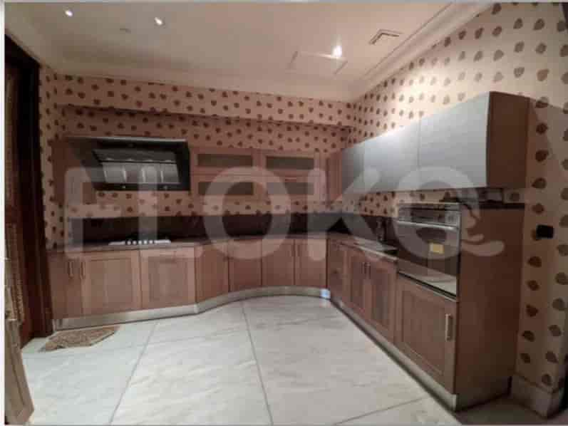 A modern kitchen with wooden cabinets, stone countertops, and built-in appliances.