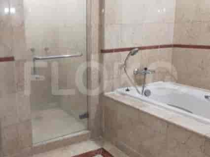 A bathroom with a bathtub and a separate glass-enclosed shower.