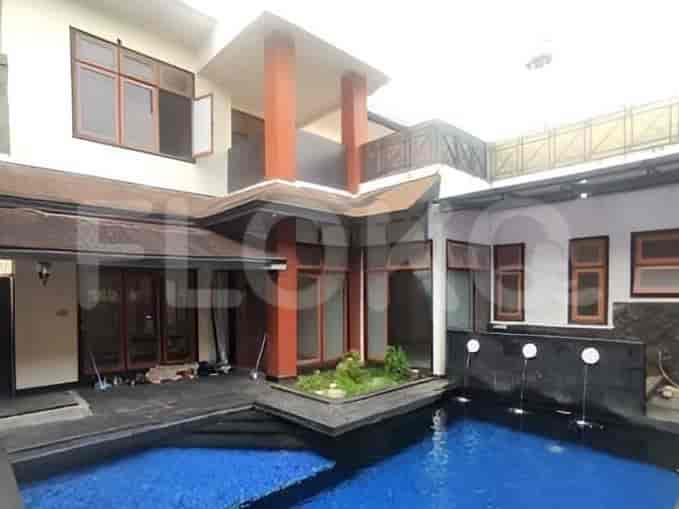 Backyard area with a swimming pool and a small garden pond.