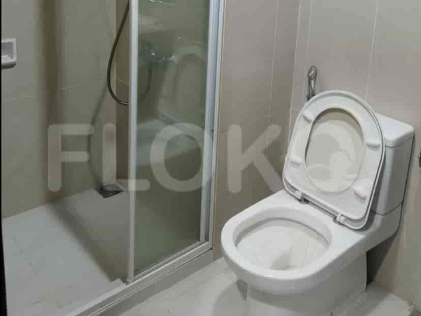 A bathroom with a toilet and a shower stall.