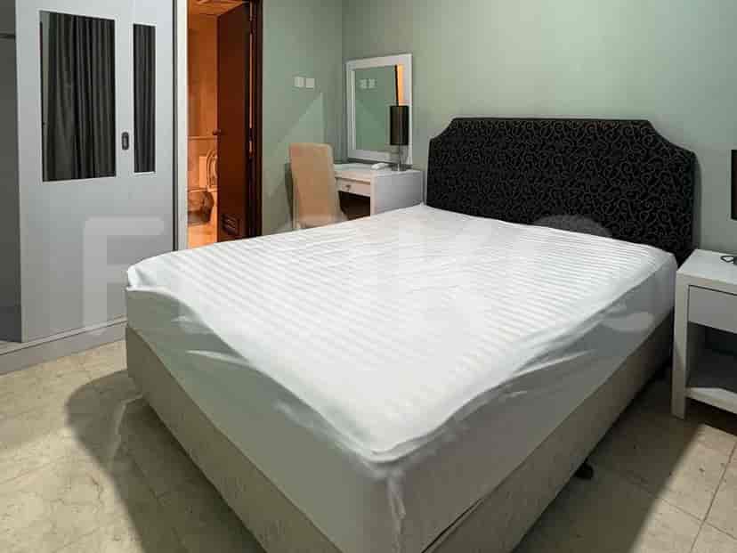Bedroom with large bed, wardrobe, and vanity.