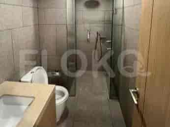 A modern bathroom with a walk-in shower, toilet, and vanity.