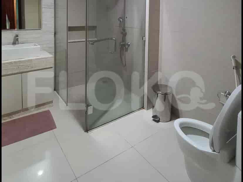 A modern bathroom with a glass shower and white fixtures.