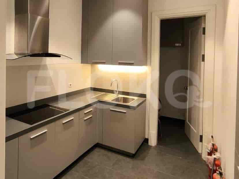 A compact, modern kitchen with grey cabinetry and integrated appliances.
