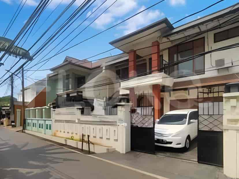 Front facade of a two-story house with a white van parked in the driveway.