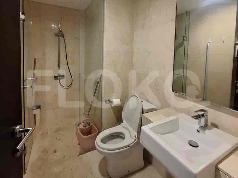 A modern bathroom with a walk-in shower, toilet, and vanity.