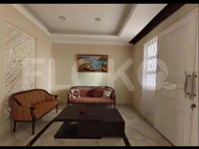 A living room with two sofas, a coffee table, and wall art.