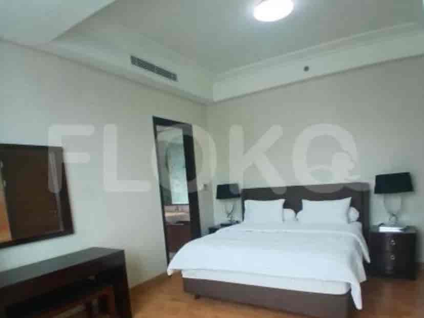 A bedroom with a king-size bed, bedside tables, and a dresser.