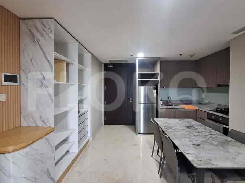 A combined kitchen and dining area with a large dining table and modern kitchen appliances.