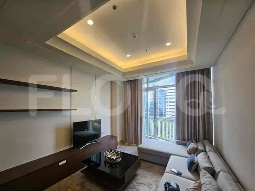 A modern living room with grey sofa, smart TV, and city view.
