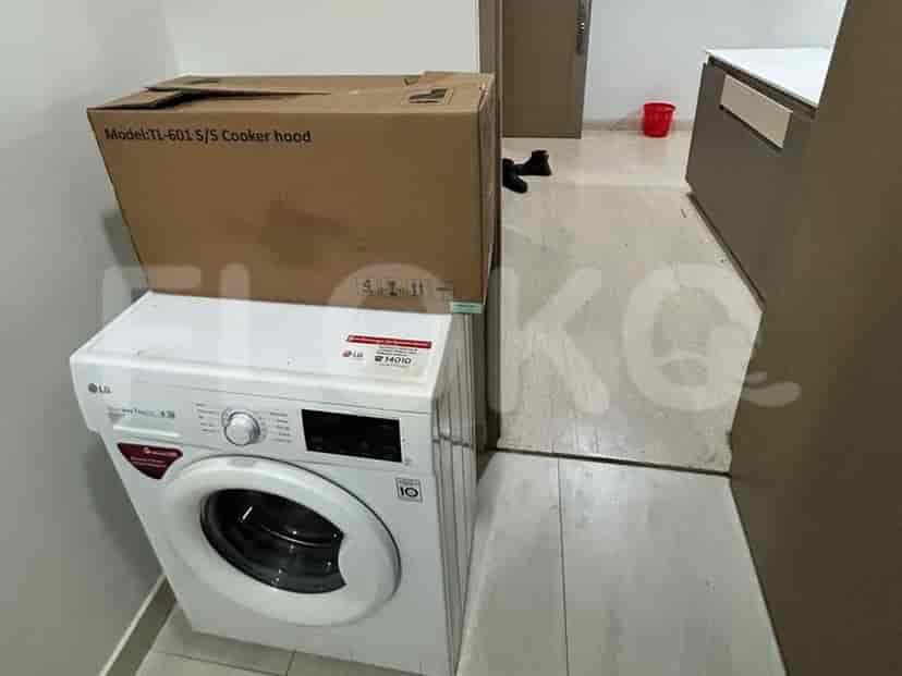 A laundry space with a washing machine.